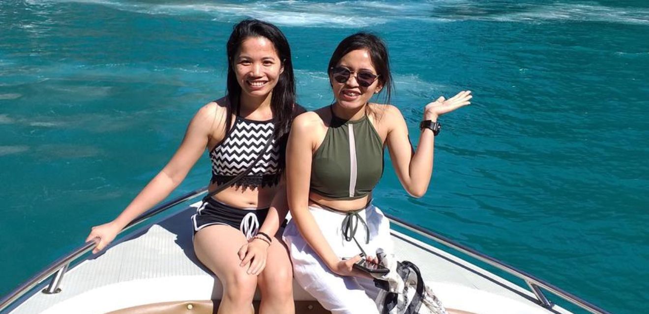 femal travellers sat on front of private speedboat phi phi boat tour