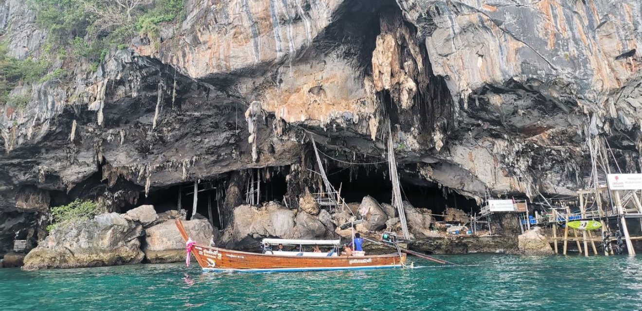 longtail boat stopped outside viking cave at koh phi phi leh national park