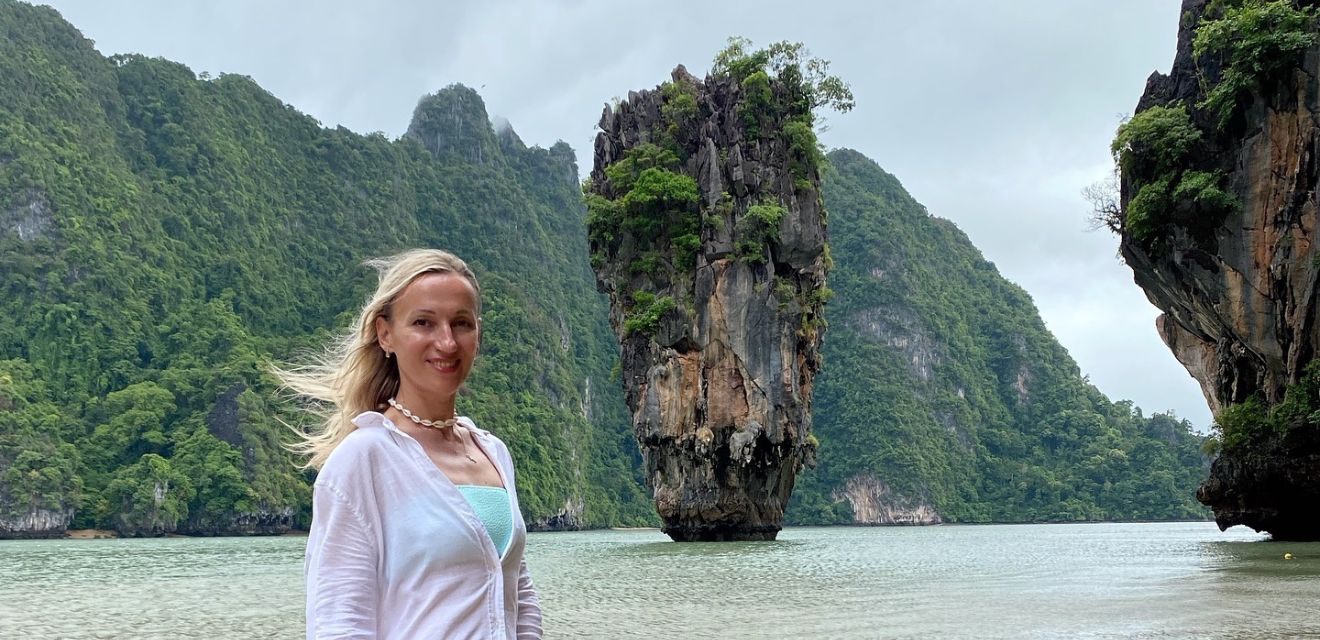 female woman tourist posing for photo on james bond island tour at koh tapu in phang nga bay