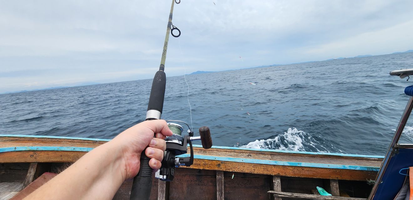 fishing tour from longtail boat with rod in thailand tour