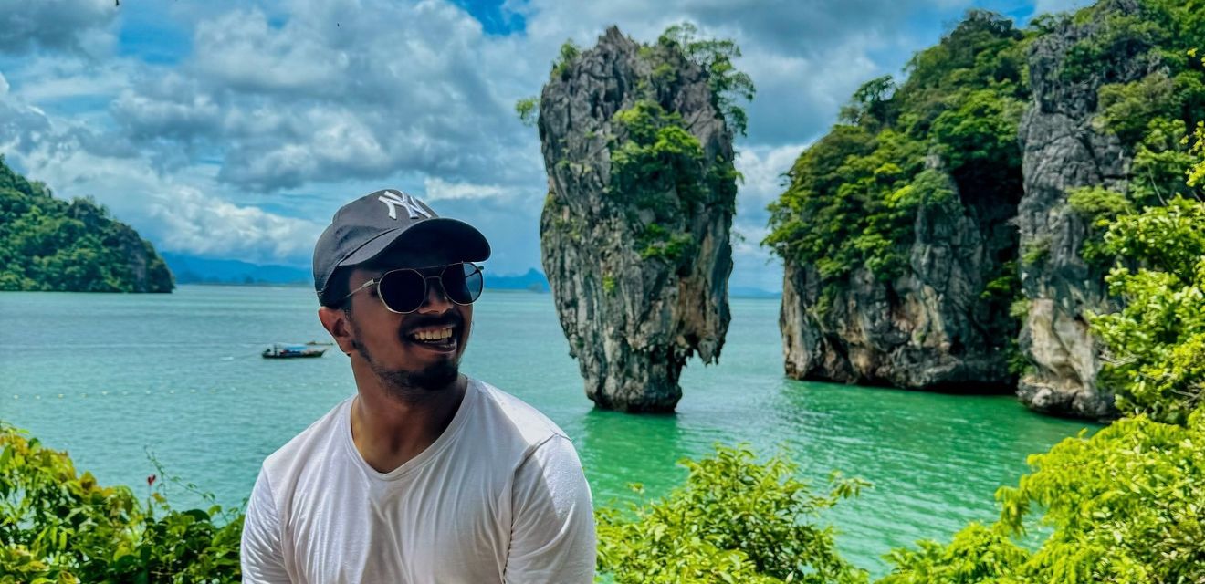 man smiling tourist photo at ohang nga bay koh tapu james bond island background