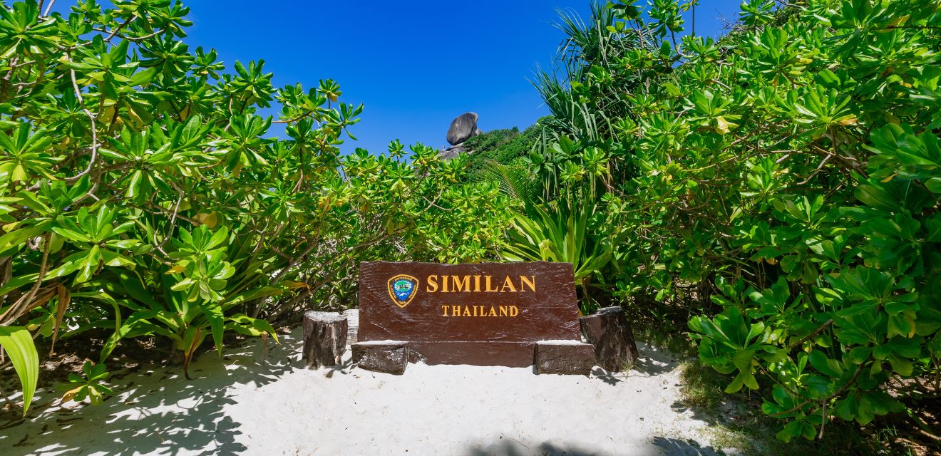 siminal island thailand wooden sign on beach tour